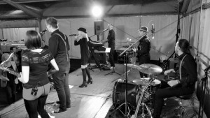Schwarz-Weiß Bild der Band beim Auftritt